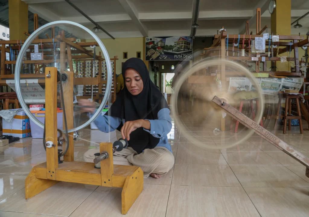 Pekerja memintal benang untuk pembuatan kain tenun puta dino di rumah Produksi Tenun Puta Dino Kayangan, Kota Tidore Kepulauan, Maluku Utara Pekerja memintal benang untuk pembuatan kain tenun puta dino di rumah Produksi Tenun Puta Dino Kayangan, Kota Tidore Kepulauan, Maluku Utara