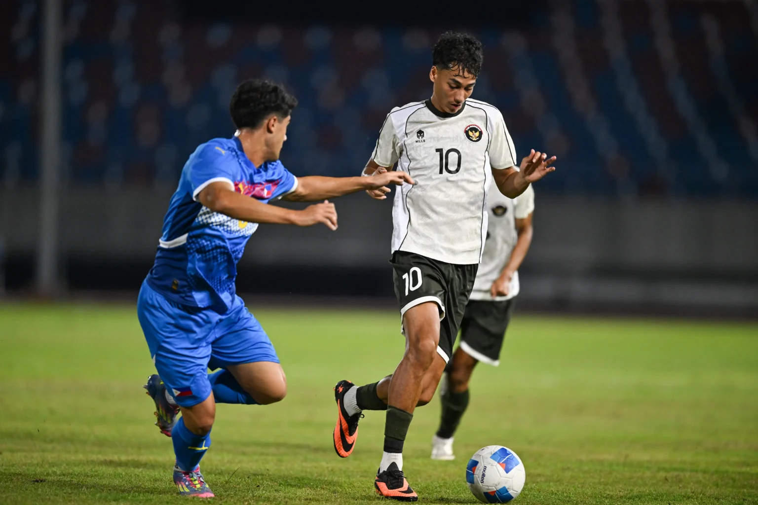 Pesepak bola Timnas Indonesia U-22 Rafael Struick (kanan) berusaha melewati hadangan pesepak bola Timnas Filipina Gavin Munes (kiri) pada pertandingan babak penyisihan Grup C Sepak Bola SEA Games 2025