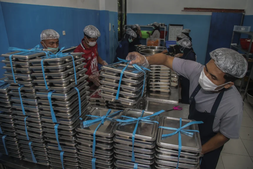 Petugas menyusun ompreng berisi Makan Bergizi Gratis (MBG) di dapur SPPG Tubo Ternate, Maluku Utara