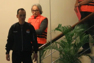 Tersangka kasus dugaan tindak pidana korupsi dalam restitusi pajak di lingkungan Kantor Pelayanan Pajak (KPP) Madya Banjarmasin Mulyono Purwo Wijoyo (kedua kiri) menggunakan rompi tahanan usai menjalani pemeriksaan di Gedung Merah Putih KPK, Jakarta, Kamis (5/2/2026).