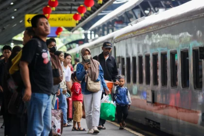 Sejumlah calon penumpang berjalan menuju kereta di Stasiun Surabaya Gubeng, Surabaya, Jawa Timur