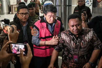 Pemilik PT Asmin Koalindo Tuhup (AKT), Samin Tan (tengah) berjalan menuju mobil tahanan usai menjalani pemeriksaan di Kejaksaan Agung, Jakarta. (Sumber: Antara Foto/Sulthony Hasanuddin)