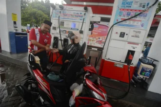 Petugas melayani pengendara kendaraan roda dua mengisi bahan bakar minyak (BBM) di Stasiun Pengisian Bahan Bakar Umum (SPBU) Bolon, Colomadu, Karanganyar, Jawa Tengah.