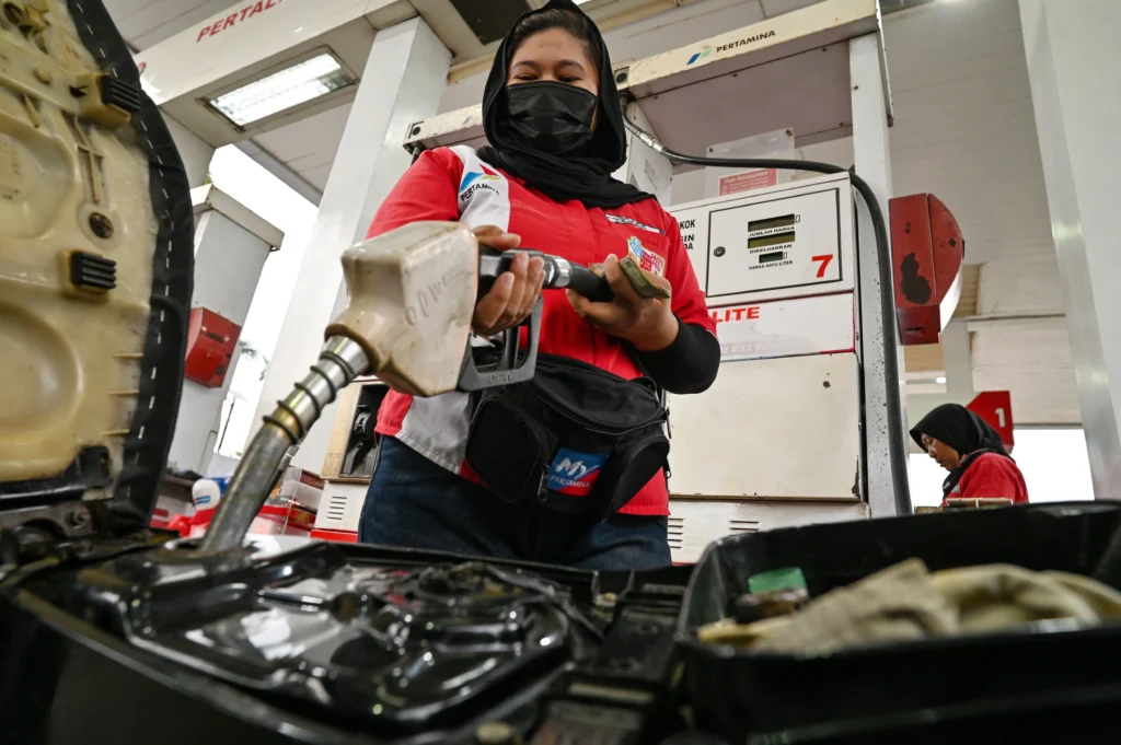 Petugas mengisi BBM jenis Pertalite ke tangki sepeda motor konsumen di salah satu SPBU Pertamina di Palu, Sulawesi Tengah.