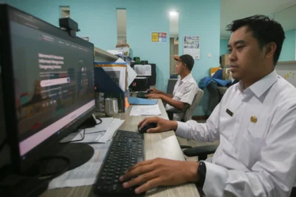 Aparatur sipil negara (ASN) memasukan data saat bekerja di kantor Puspemkot Tangerang Selatan di Ciputat, Tangerang Selatan