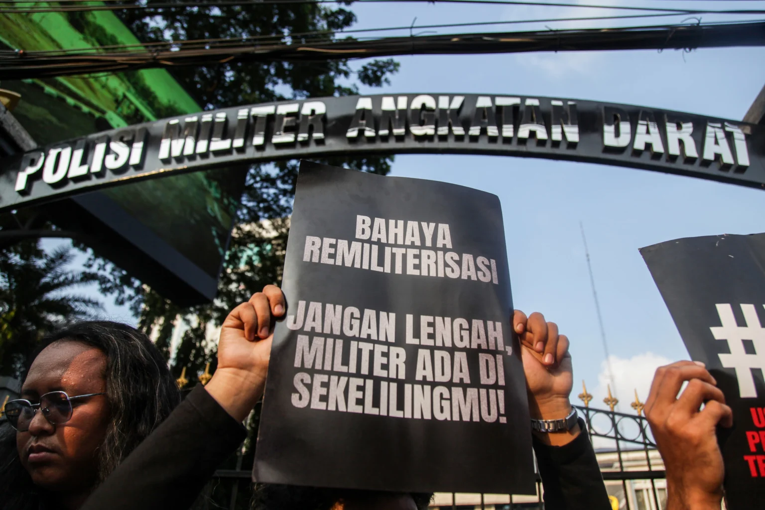 Aktivis membentangkan poster saat aksi solidaritas untuk Andrie Yunus di depan Markas Pusat Polisi Militer Angkatan Darat, Jakarta, Kamis (16/4/2026). Mereka menuntut persidangan kasus penyiraman air keras terhadap Andrie Yunus digelar di pengadilan sipil.