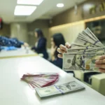 Karyawan menunjukkan uang pecahan dolar Amerika Serikat (AS) di gerai penukaran mata uang asing Ayu Masagung, Jakarta, Selasa (5/5/2026). Nilai tukar rupiah terhadap dolar AS bergerak melemah 11 poin atau 0,07 persen menjadi Rp17.405 per dolar AS dari penutupan sebelumnya di level Rp17.394 per dolar AS, yang dipengaruhi eskalasi di Timur Tengah yang semakin memanas.