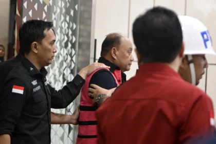 Tersangka dugaan tindak pidana korupsi tata kelola program Makan Bergizi Gratis (MBG) pada Badan Gizi Nasional (BGN) Dadan Hindayana (tengah) berjalan menuju mobil tahanan di Kejaksaan Agung, Jakarta, Rabu (3/6/2026).