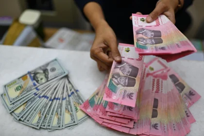 Karyawan menghitung uang pecahan rupiah dan dolar Amerika Serikat (AS) di gerai penukaran mata uang asing Ayu Masagung, Jakarta. (Sumber: Antara Foto/Indrianto Eko Suwarso/kye)