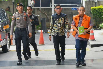 Tersangka kasus dugaan pemerasan, Sudewo (kanan) berjalan menuju ruang pemeriksaan di Gedung Merah Putih KPK, Jakarta, Selasa (19/5/2026).