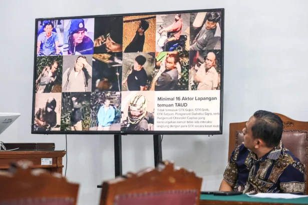 Tim Bidang hukum Polda Metro Jaya melihat layar yang menampilkan bukti dalam sidang lanjutan praperadilan kasus penyiraman air keras kepada aktivis KontraS Andrie Yunus di Pengadilan Negeri Jakarta Selatan, Jakarta, Jumat (22/5/2026).