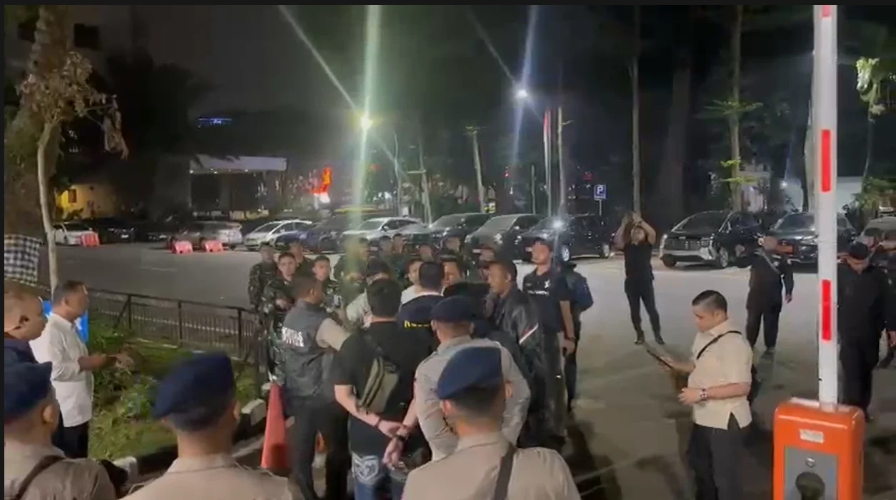 Tangkapan layar yang menampilkan belasan pria berseragam dinas dan membawa senjata laras panjang di kawasan Polda Metro Jaya