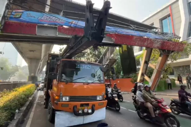Sebuah truk pengangkut alat berat tersangkut Jembatan Penyebrangan Orang di jalan Kapten Tendean, Mampang Prapatan, Jakarta Selatan, Selasa, 14 Juli 2026.