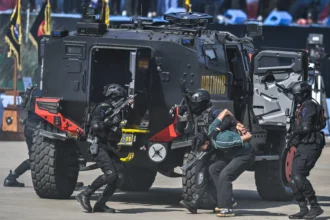 Anggota Polri dari Korps Brimob memperagakan simulasi penangkapan saat peringatan HUT Ke-80 Bhayangkara di Pusat Latihan Brimob Polri, Cikeas, Bogor, Jawa Barat, Rabu (1/7/2026).