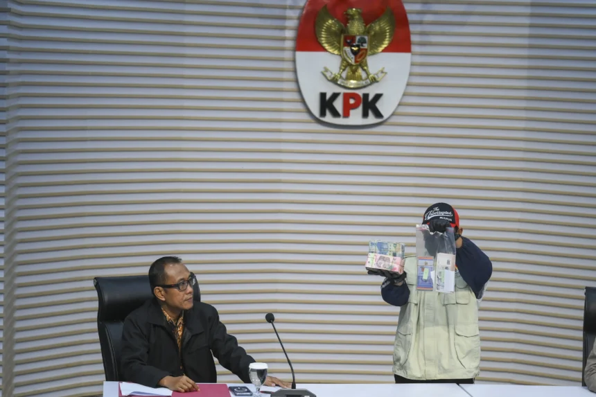 Plt. Direktur Penyidikan KPK Achmad Taufik Husein (kiri) menyaksikan petugas KPK menunjukkan barang bukti uang tunai saat konferensi pers operasi tangkap tangan Bupati Langkat Syah Afandin di Gedung Merah Putih KPK, Jakarta, Jumat (3/7/2026). (Sumber: Antara Foto/Hafidz Mubarak A/sgd)