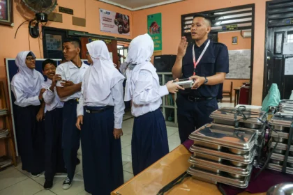 Guru membagikan makan bergizi gratis (MBG) kepada siswa disabilitas di Sekolah Luar Biasa (SLB) B-C Bina Karya Insani, Duren Sawit, Jakarta, Senin (27/7/2026).