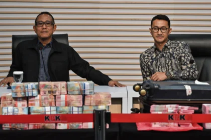 Plt. Direktur Penyidikan KPK Achmad Taufik Husein (kiri) didampingi Juru Bicara KPK Budi Prasetyo (kanan) mengamati barang bukti uang saat memberikan keterangan pers terkait operasi tangkap tangan (OTT) yang menjerat Bupati Pemalang Anom Widiyantoro di Gedung Merah Putih KPK, Jakarta, Kamis (30/7/2026).