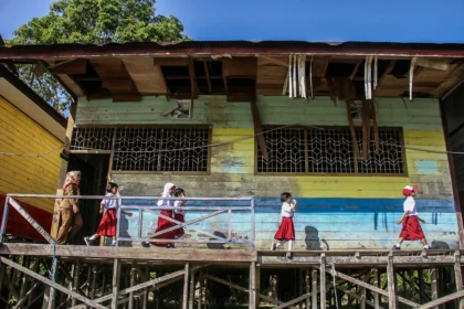 Seorang guru mendampingi siswa memperkenalkan lingkungan sekolah saat Masa Pengenalan Lingkungan Sekolah (MPLS) di SD Negeri 01 Petuk Katimpun, Palangka Raya, Kalimantan Tengah, Senin (13/7/2026).