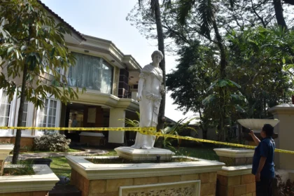 Jurnalis televisi merekam suasana rumah mewah yang dipasangi garis polisi usai penggeledahan di kawasan Sentul, Babakan Madang, Kabupaten Bogor, Jawa Barat, Kamis (9/7/2026).