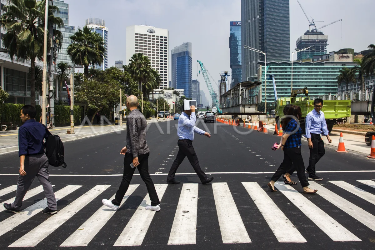 Pejalan kaki melintasi "pelican crossing" untuk menyeberang jalan di kawasan Bundaran Hotel Indonesia, Jakarta, Selasa (31/7/2018).