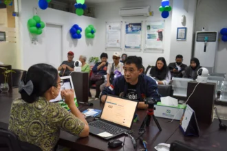 Petugas melayani warga peserta program BPJS Kesehatan di Kantor BPJS Kesehatan Cabang Jakarta Pusat, Jakarta, Rabu (22/7/2026).