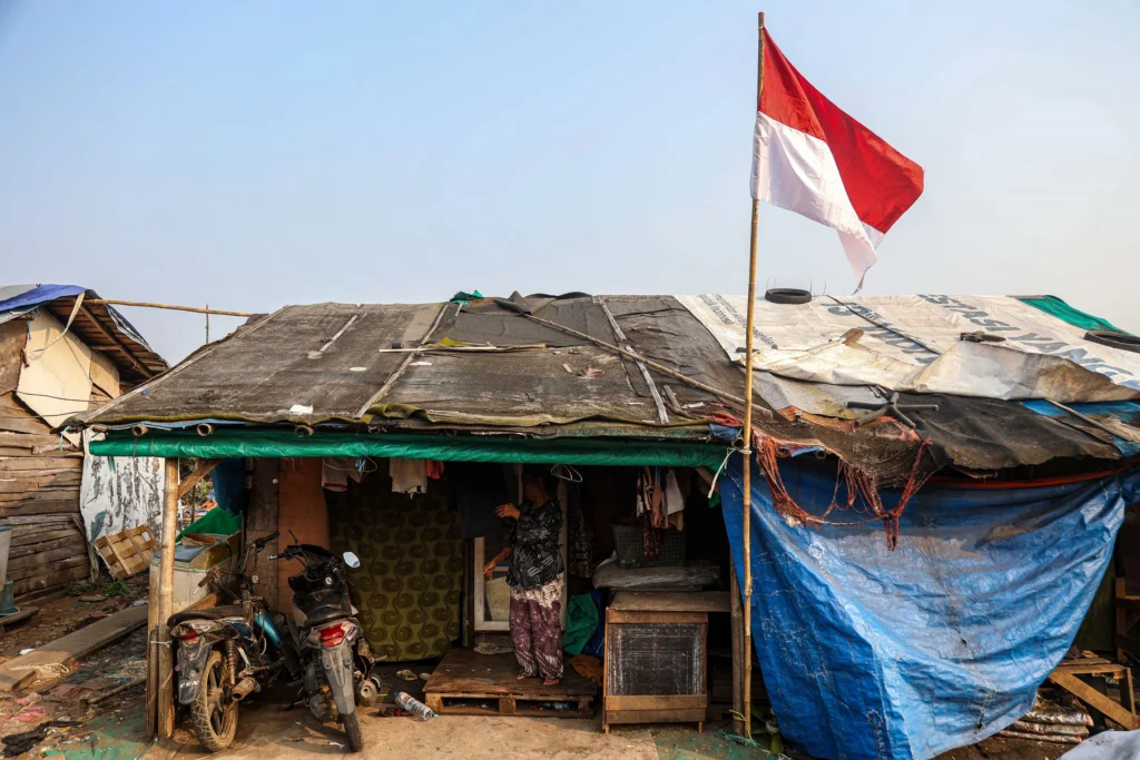 Seorang warga berdiri di depan rumahnya usai menjemur pakaian di Kampung Pemulung Cikiwul, Bantargebang, Kota Bekasi, Jawa Barat. (Sumber: Antara Foto/Darryl Ramadhan/tom)