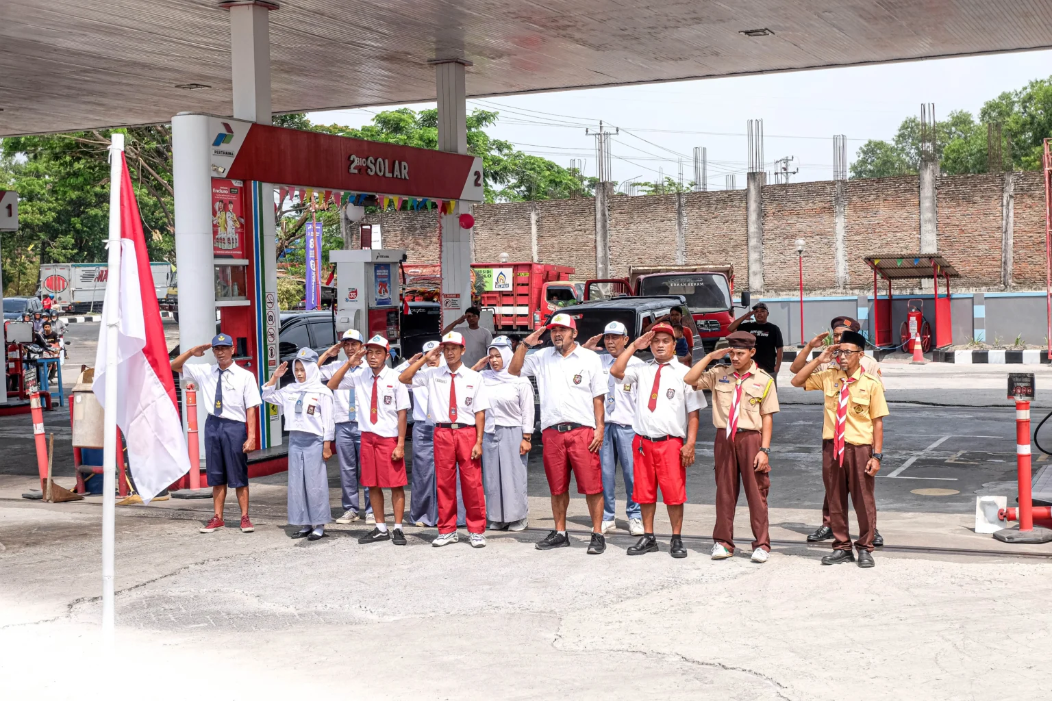 Petugas SPBU berbusana siswa sekolah mengikuti upacara pengibaran bendera Merah Putih di SPBU Plesungan, Kabupaten Karanganyar, Jawa Tengah, Senin (17/8/2026).
